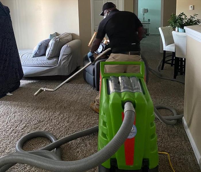 SERVPRO tech removing water from carpet